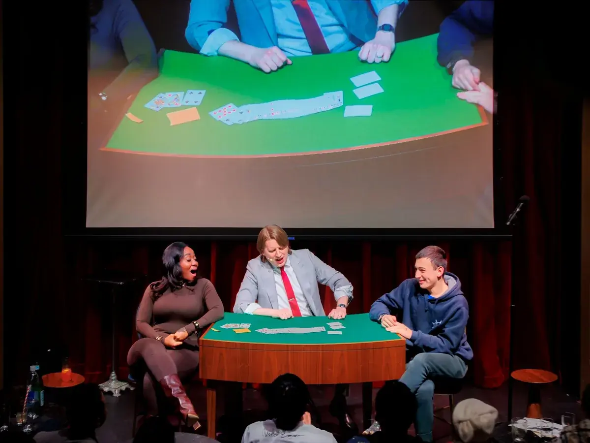 The Close-Up Show at Chicago Magic Lounge — Three magicians perform close-up magic on stage, projected live so the entire audience can see every detail.